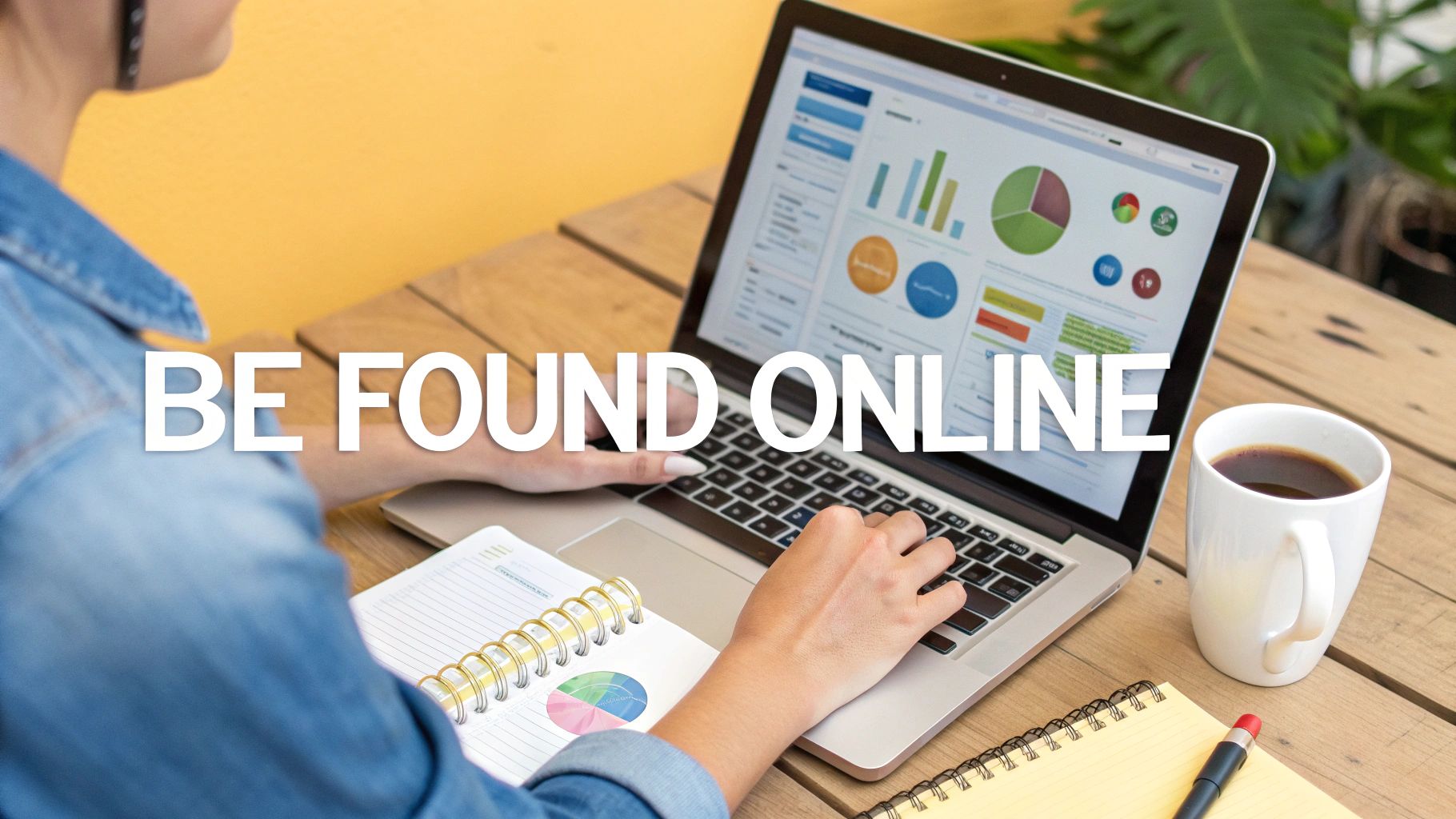 Woman working on a laptop displaying data analytics, with notebooks and coffee, promoting online visibility.